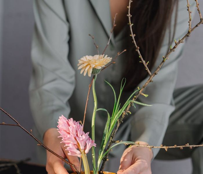 Person meditating peacefully in a room with natural light.